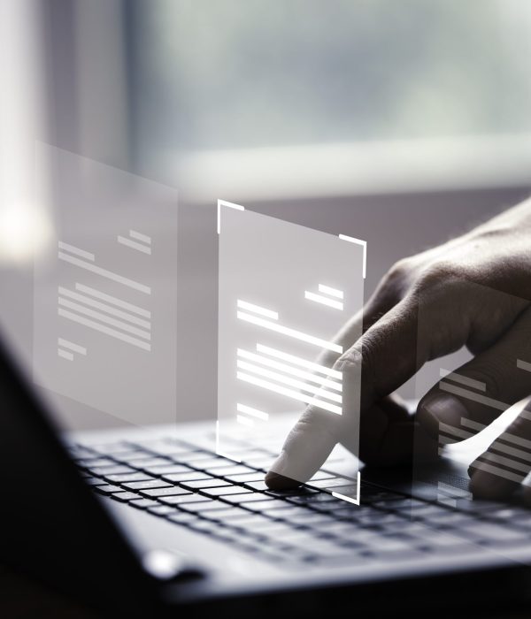 Hand using laptop computer with virtual screen and document for online approve paperless quality assurance and ERP management concept.